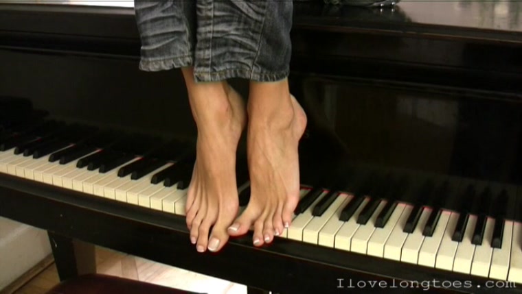Long toes playing grand piano
